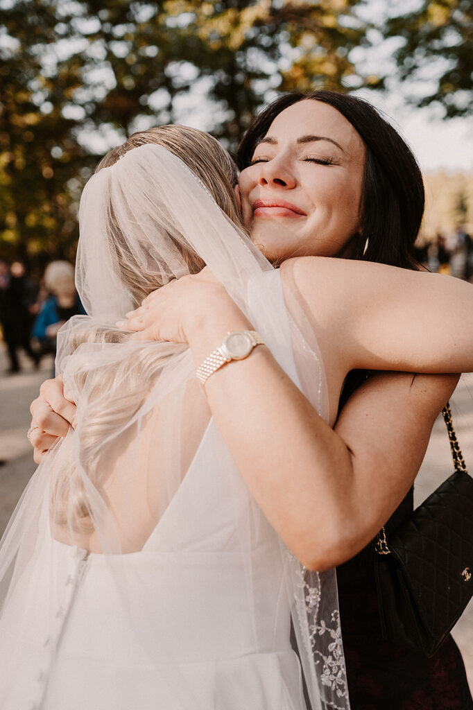 Bride hugging guests - editorial wedding photographer