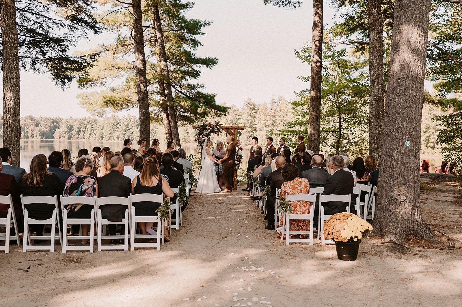 Couple holding hands during outdoor Muskoka wedding ceremony at Rocky Crest Resort